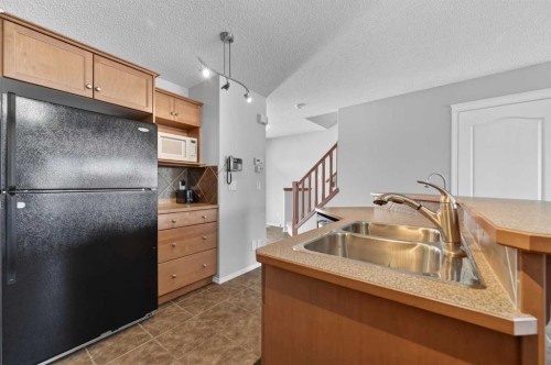78 Cranberry Close Se, Calgary, AB - Indoor Photo Showing Kitchen With Double Sink