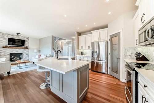127 Cimarron Park Circle, Okotoks, AB - Indoor Photo Showing Kitchen With Fireplace With Stainless Steel Kitchen With Double Sink With Upgraded Kitchen