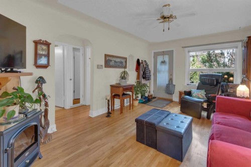 2318 Bowness Road Nw, Calgary, AB - Indoor Photo Showing Living Room With Fireplace