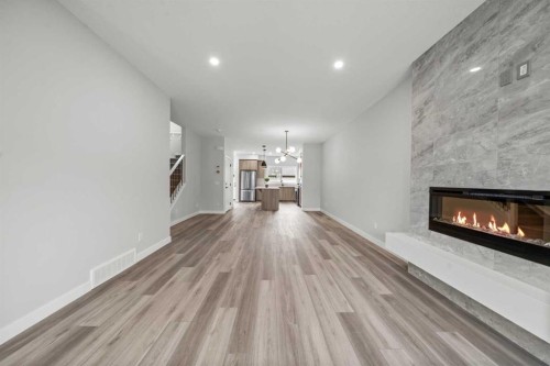 46 Versant View Sw, Calgary, AB - Indoor Photo Showing Living Room With Fireplace