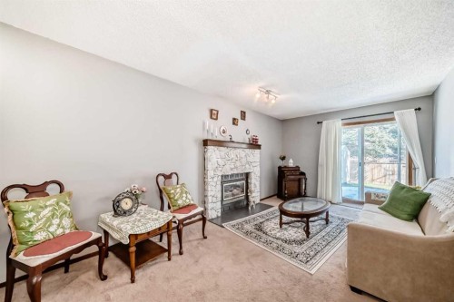 216 Hawkwood Boulevard Nw, Calgary, AB - Indoor Photo Showing Living Room With Fireplace