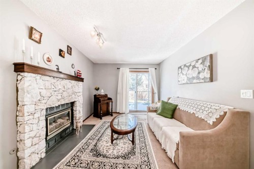 216 Hawkwood Boulevard Nw, Calgary, AB - Indoor Photo Showing Living Room With Fireplace