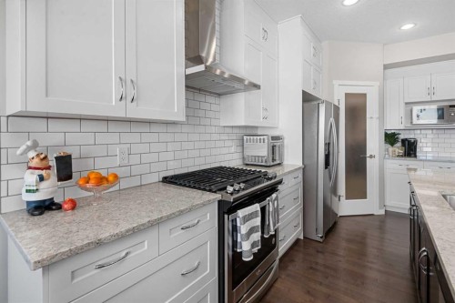 49 Tuscany Ridge Circle Nw, Calgary, AB - Indoor Photo Showing Kitchen With Stainless Steel Kitchen With Upgraded Kitchen