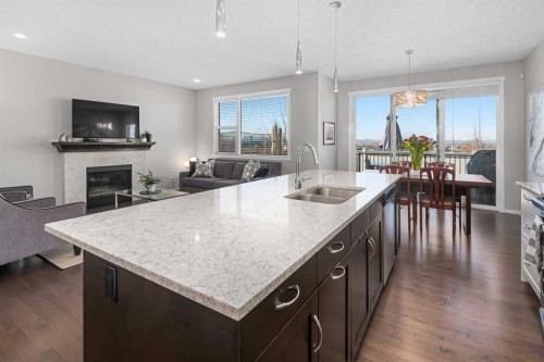 49 Tuscany Ridge Circle Nw, Calgary, AB - Indoor Photo Showing Kitchen With Fireplace With Double Sink With Upgraded Kitchen