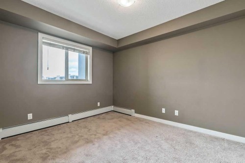 9410-403 Mackenzie Way Sw, Airdrie, AB - Indoor Photo Showing Other Room