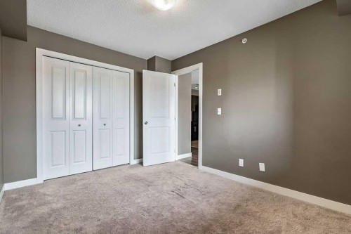 9410-403 Mackenzie Way Sw, Airdrie, AB - Indoor Photo Showing Other Room