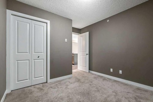 9410-403 Mackenzie Way Sw, Airdrie, AB - Indoor Photo Showing Other Room