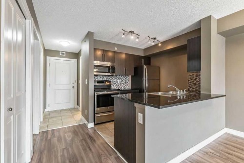 9410-403 Mackenzie Way Sw, Airdrie, AB - Indoor Photo Showing Kitchen With Double Sink With Upgraded Kitchen