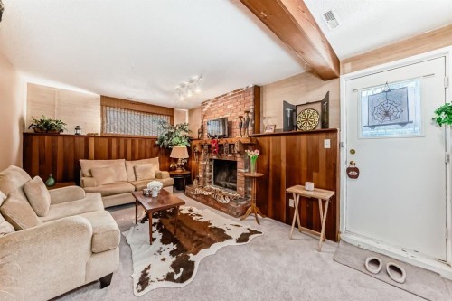 76 Edgewood Drive Nw, Calgary, AB - Indoor Photo Showing Living Room With Fireplace
