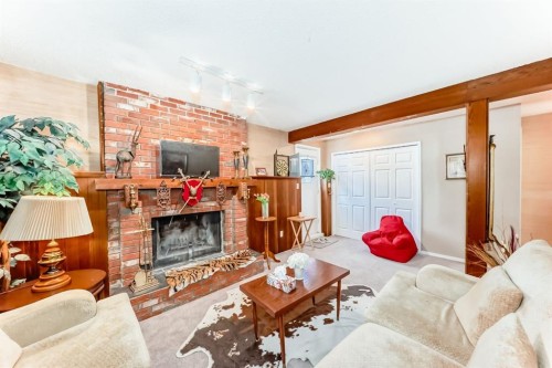 76 Edgewood Drive Nw, Calgary, AB - Indoor Photo Showing Living Room With Fireplace
