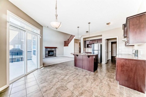 60 Sunset Circle, Cochrane, AB - Indoor Photo Showing Kitchen With Fireplace