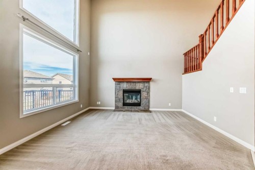 60 Sunset Circle, Cochrane, AB - Indoor Photo Showing Living Room With Fireplace