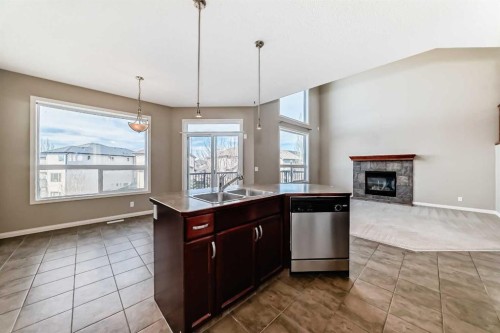 60 Sunset Circle, Cochrane, AB - Indoor Photo Showing Kitchen With Fireplace With Double Sink