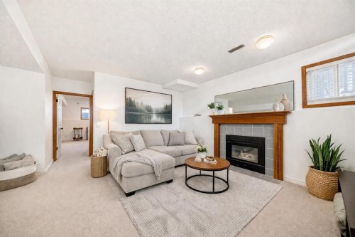 110 Erin Meadow Close Se, Calgary, AB - Indoor Photo Showing Living Room With Fireplace