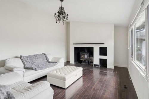 214 Springwood Place Sw, Calgary, AB - Indoor Photo Showing Living Room With Fireplace