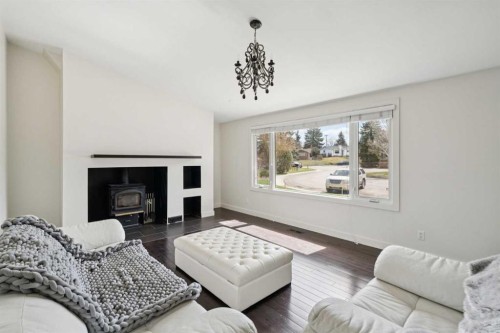 214 Springwood Place Sw, Calgary, AB - Indoor Photo Showing Living Room With Fireplace