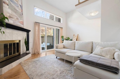 18 Glamis Gardens Sw, Calgary, AB - Indoor Photo Showing Living Room With Fireplace