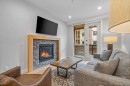 205A-1012 Spring Creek Drive, Canmore, AB  - Indoor Photo Showing Living Room With Fireplace 