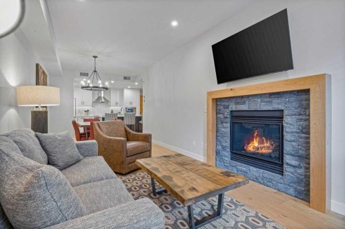 205A-1012 Spring Creek Drive, Canmore, AB - Indoor Photo Showing Living Room With Fireplace