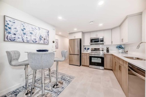 32 Sugarsnap Way Se, Calgary, AB - Indoor Photo Showing Kitchen With Stainless Steel Kitchen With Double Sink With Upgraded Kitchen