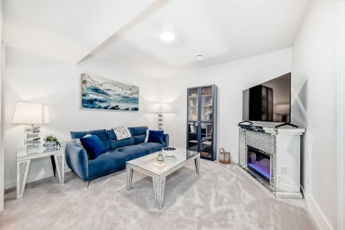 32 Sugarsnap Way Se, Calgary, AB - Indoor Photo Showing Living Room With Fireplace