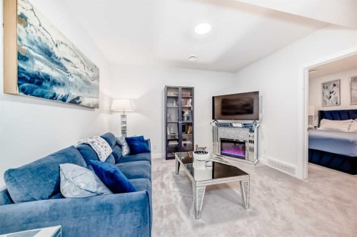 32 Sugarsnap Way Se, Calgary, AB - Indoor Photo Showing Living Room With Fireplace