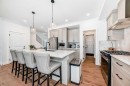 32 Sugarsnap Way Se, Calgary, AB  - Indoor Photo Showing Kitchen With Stainless Steel Kitchen With Upgraded Kitchen 