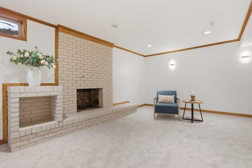 431 Queen Charlotte Drive Se, Calgary, AB - Indoor Photo Showing Other Room With Fireplace