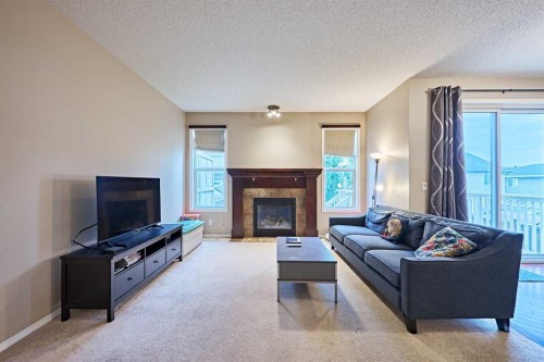 789 Panatella Boulevard Nw, Calgary, AB - Indoor Photo Showing Living Room With Fireplace