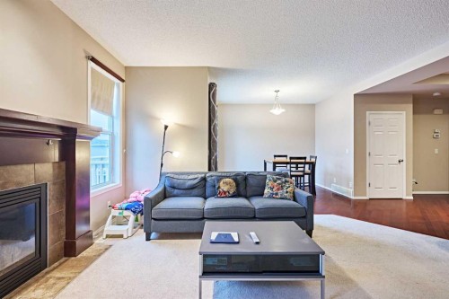 789 Panatella Boulevard Nw, Calgary, AB - Indoor Photo Showing Living Room With Fireplace