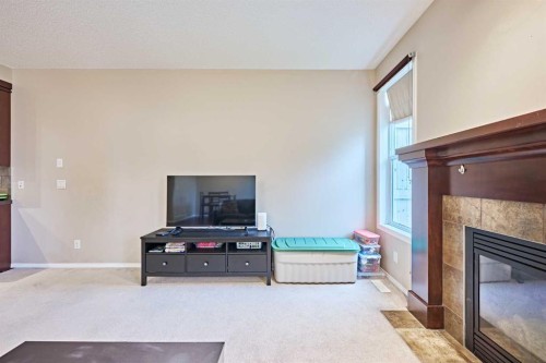789 Panatella Boulevard Nw, Calgary, AB - Indoor Photo Showing Living Room With Fireplace