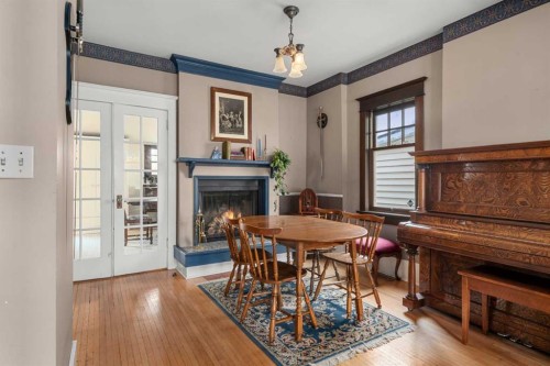 620 19 Avenue Nw, Calgary, AB - Indoor Photo Showing Dining Room With Fireplace