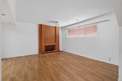 900 Abbeydale Drive Ne, Calgary, AB - Indoor Photo Showing Other Room With Fireplace