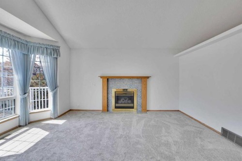 90 Martinridge Crescent Ne, Calgary, AB - Indoor Photo Showing Other Room With Fireplace