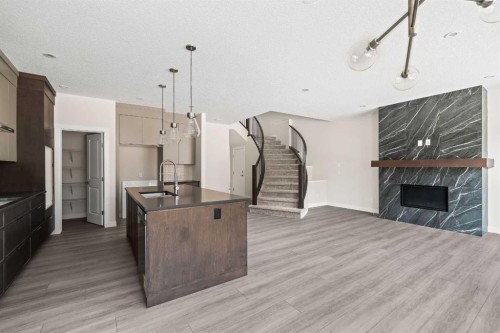 506 Lucas Way Nw, Calgary, AB - Indoor Photo Showing Kitchen With Fireplace