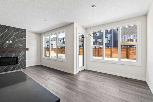 506 Lucas Way Nw, Calgary, AB - Indoor Photo Showing Living Room With Fireplace