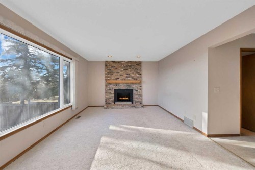 68 Hawkfield Crescent Nw, Calgary, AB - Indoor Photo Showing Living Room With Fireplace
