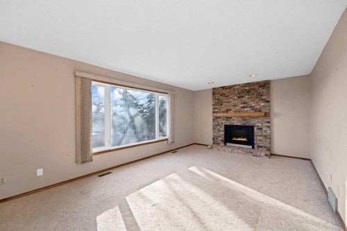 68 Hawkfield Crescent Nw, Calgary, AB - Indoor Photo Showing Living Room With Fireplace