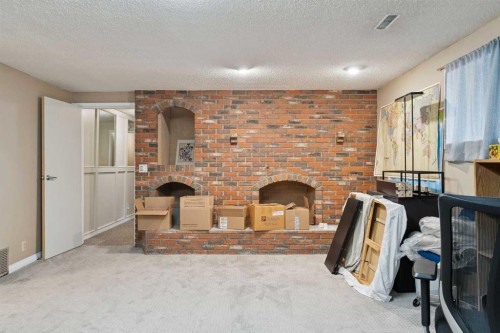 7 Willow Vale, Rural Rocky View County, AB - Indoor Photo Showing Other Room With Fireplace
