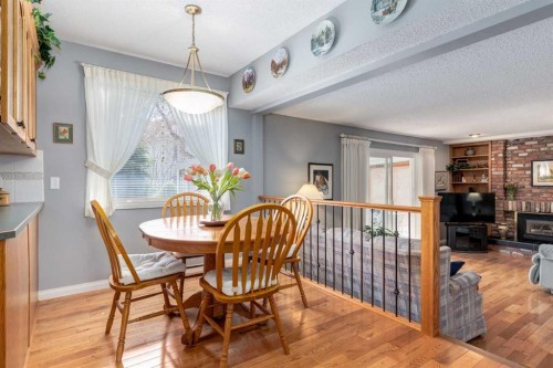 107 Valhalla Crescent Nw, Calgary, AB - Indoor Photo Showing Dining Room With Fireplace