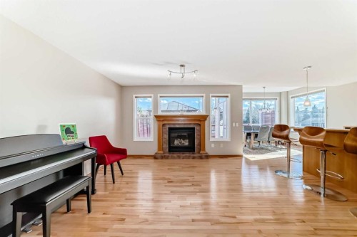 84 Cougarstone Square Sw, Calgary, AB - Indoor Photo Showing Living Room With Fireplace