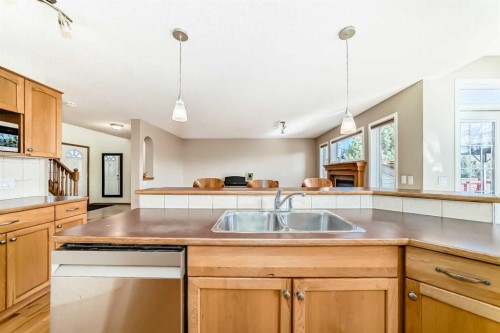 84 Cougarstone Square Sw, Calgary, AB - Indoor Photo Showing Kitchen With Double Sink