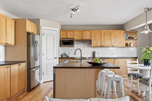 95 Crestmont Drive Sw, Calgary, AB - Indoor Photo Showing Kitchen With Stainless Steel Kitchen With Double Sink