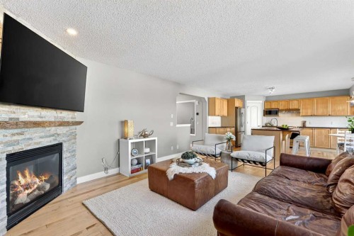 95 Crestmont Drive Sw, Calgary, AB - Indoor Photo Showing Living Room With Fireplace