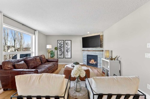 95 Crestmont Drive Sw, Calgary, AB - Indoor Photo Showing Living Room With Fireplace
