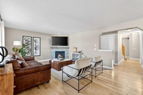 95 Crestmont Drive Sw, Calgary, AB - Indoor Photo Showing Living Room With Fireplace