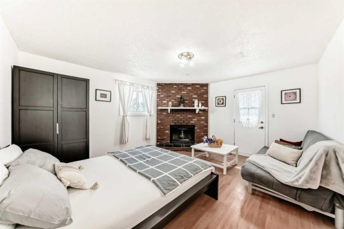 451 Huntbourne Hill Ne, Calgary, AB - Indoor Photo Showing Bedroom With Fireplace