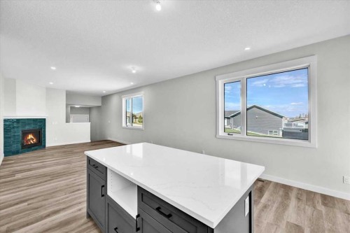 2016 30 Avenue, Nanton, AB - Indoor With Fireplace