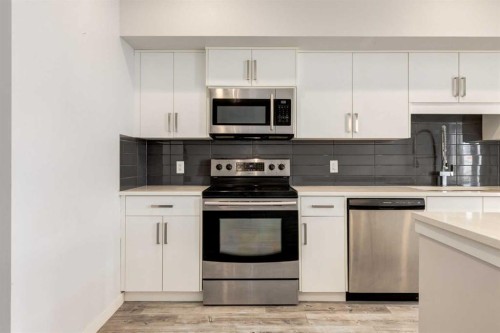 207-10 Westpark Link, Calgary, AB - Indoor Photo Showing Kitchen With Stainless Steel Kitchen With Upgraded Kitchen