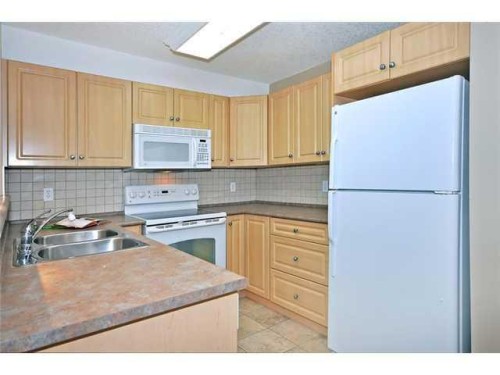 2310-10 Prestwick Bay Se, Calgary, AB - Indoor Photo Showing Kitchen With Double Sink